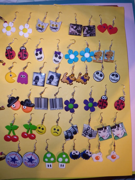 there is a wall full of different images and earrings