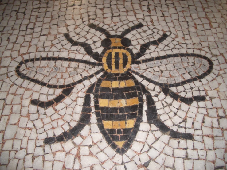 a tiled floor with a small bee on top of it