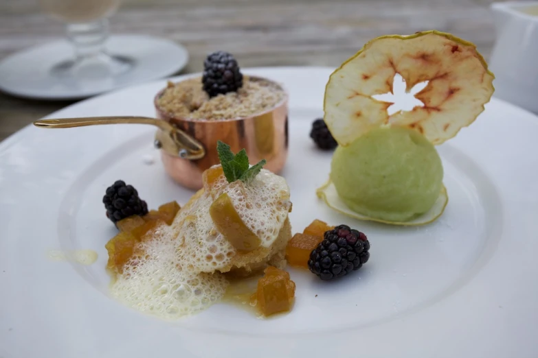 three desserts on a plate in an outdoor setting