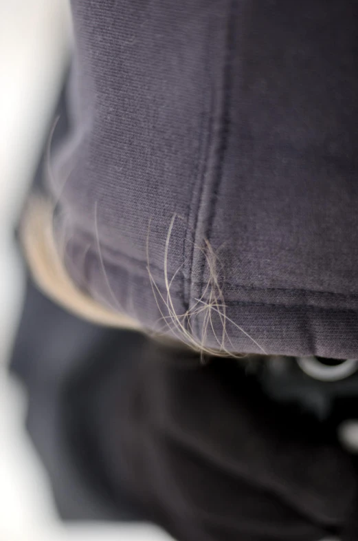 a closeup of a pillow covered in thin silver thread