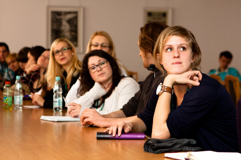 a group of people sitting at a table