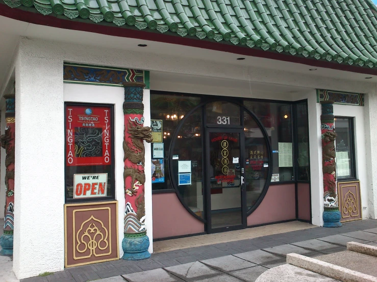 an ornately decorated building with the front entrance door open