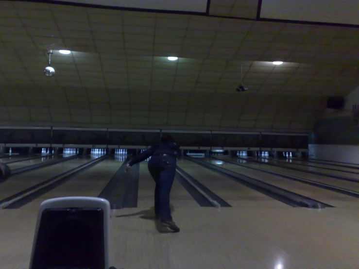 two people on a bowling alley in the night