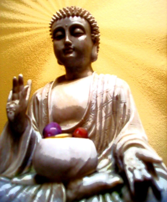 the buddha statue is surrounded by three balls