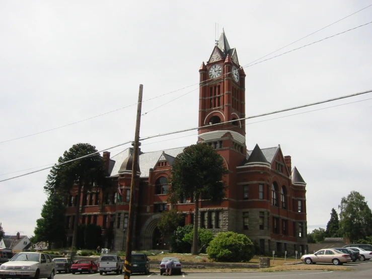 a clock tower in the middle of a building next to street