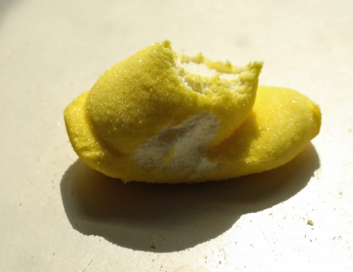 an unpeeled yellow object sitting on the counter