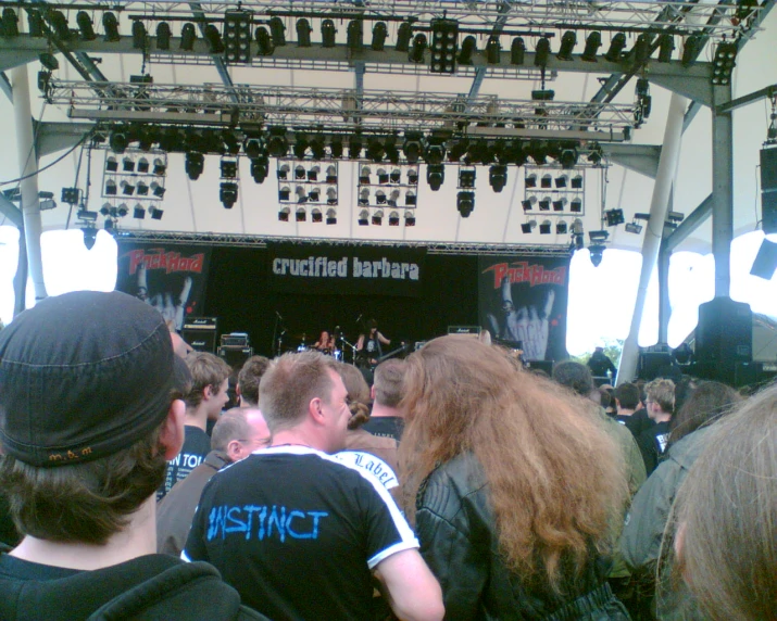 large group of people in front of an stage and speakers