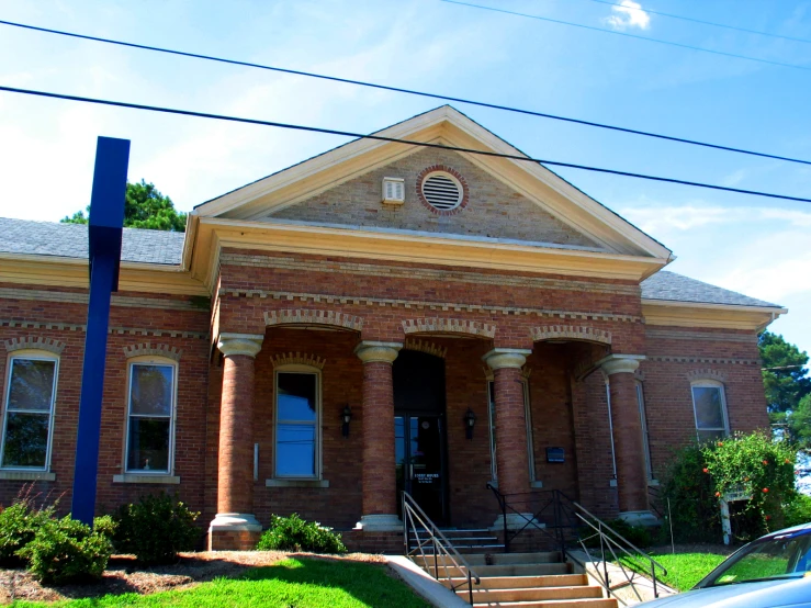 an old brick building with a tall front porch