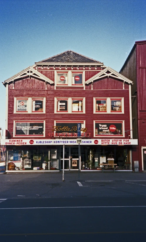 a building with red paint has a store on it