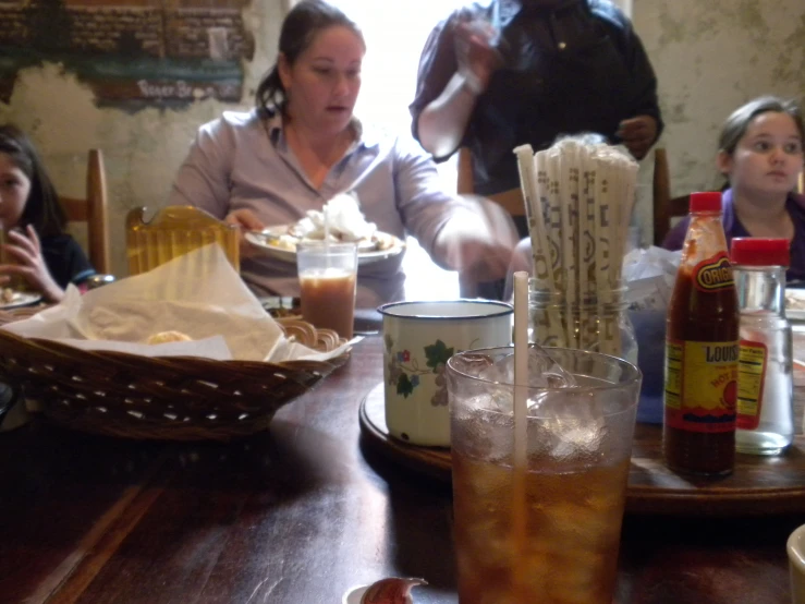 people sitting at a dining table eating and drinking