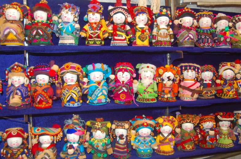 many colorful figurines are on a shelf