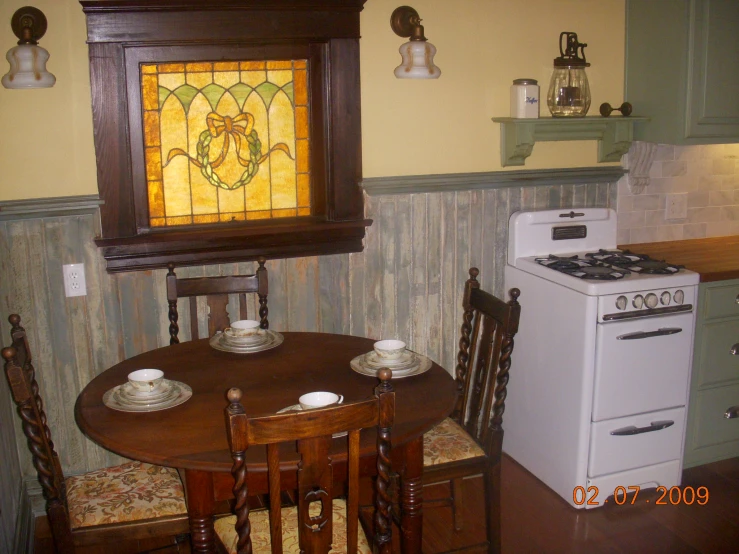 a small kitchen with a stove, sink and oven