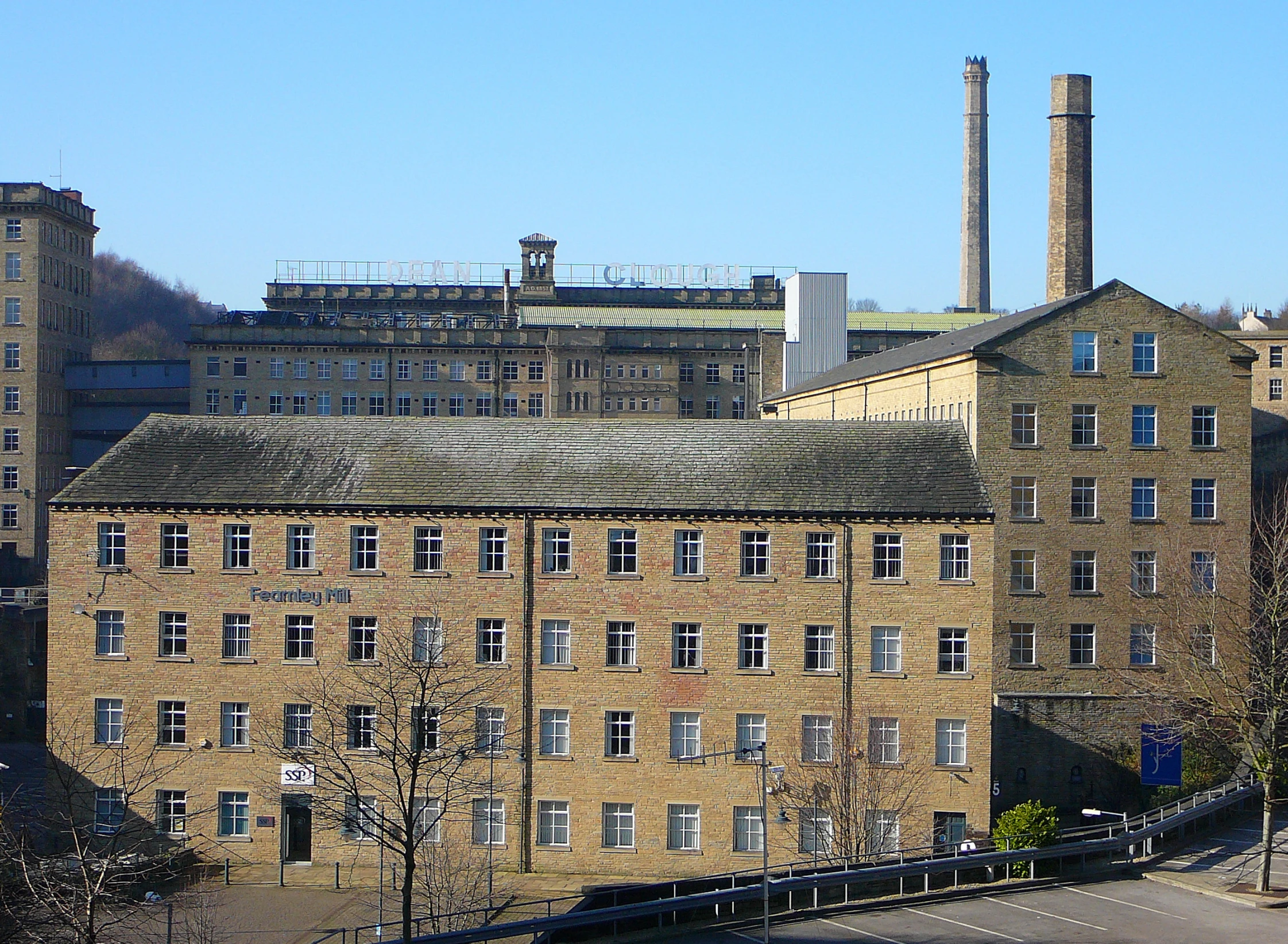 an old factory with an industrial chimneys in the background