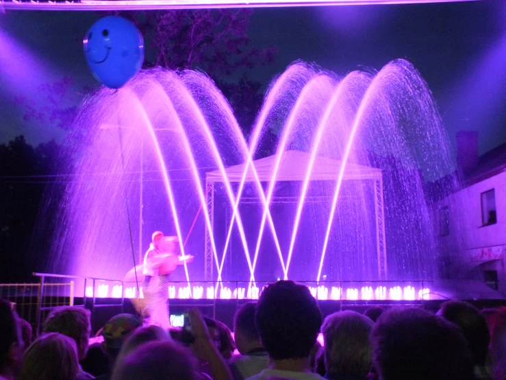 a person in a crowd with some light show