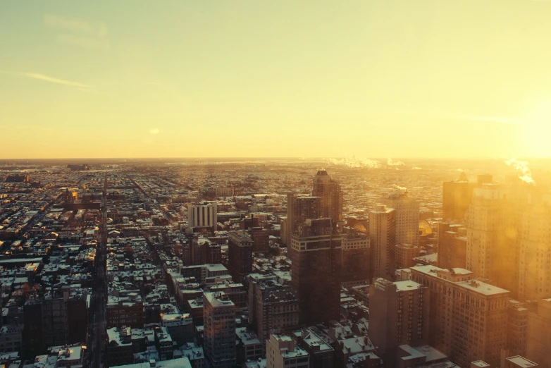 the sun is just rising above buildings in the city