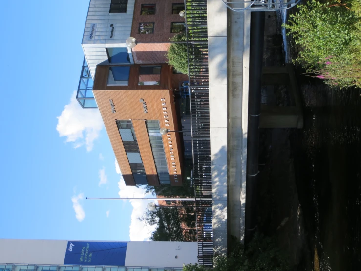 a building with a bridge leading across the river to another building