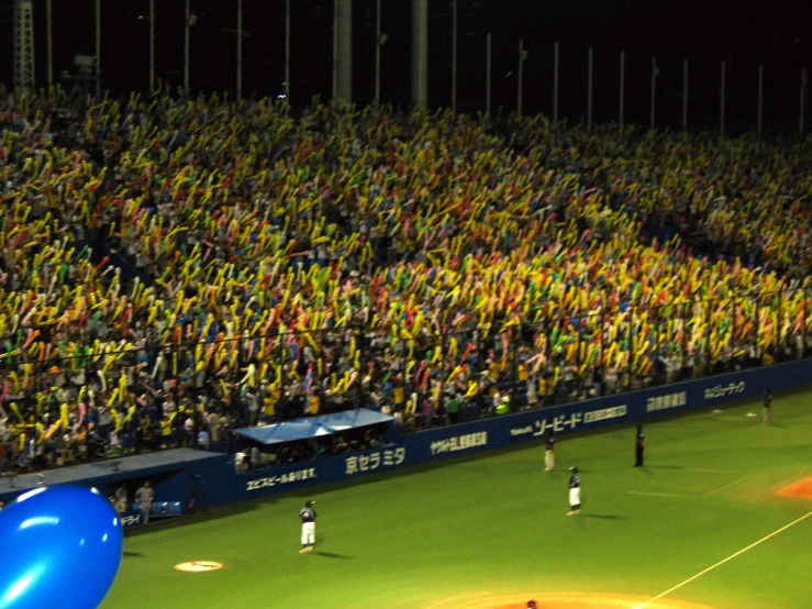 a large crowd is at a baseball game