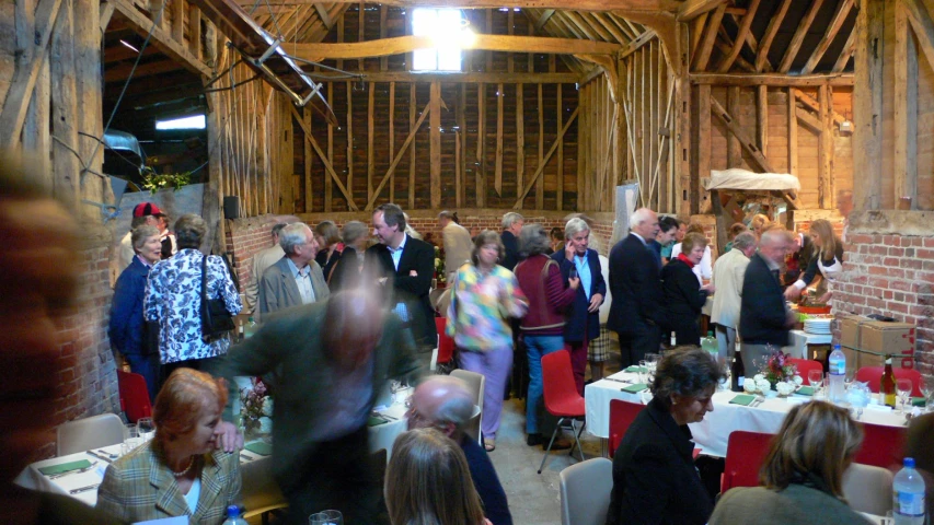 there are a lot of people gathered together in the barn