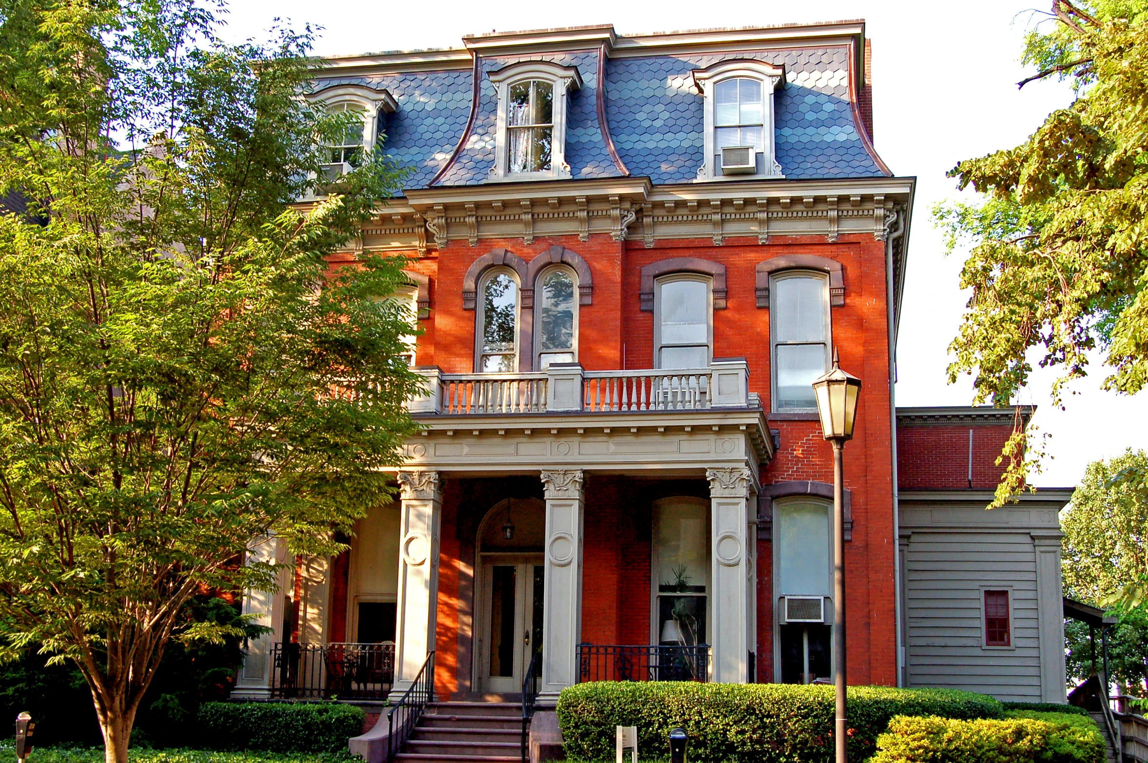 a building with a clock on the front and trees in the front