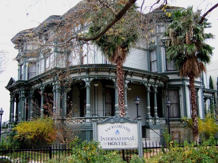 an old style house with large palm trees