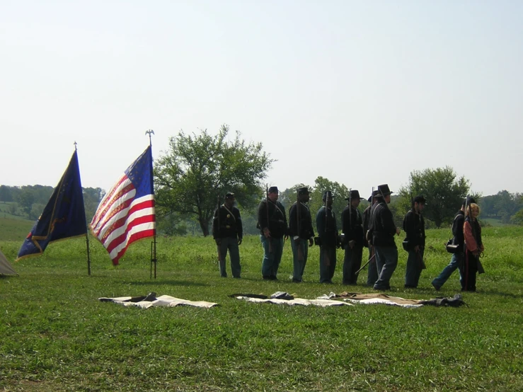 the men stand near american flags near flags