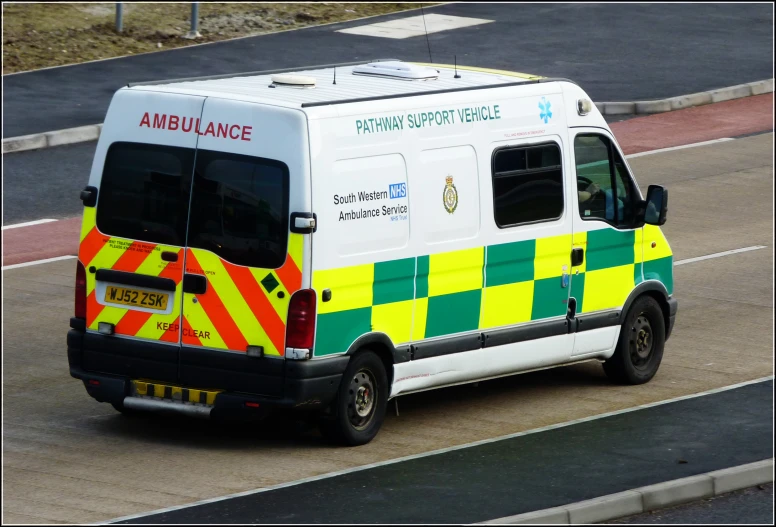 an ambulance parked on the side of a road