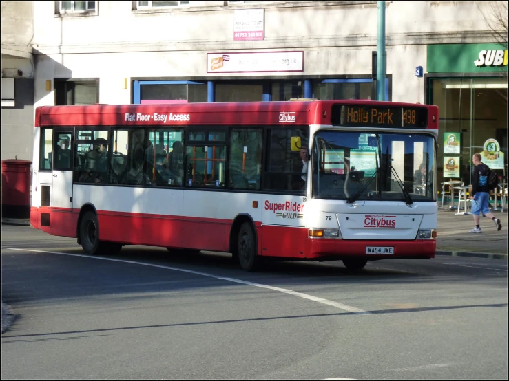 the city bus is traveling down the street