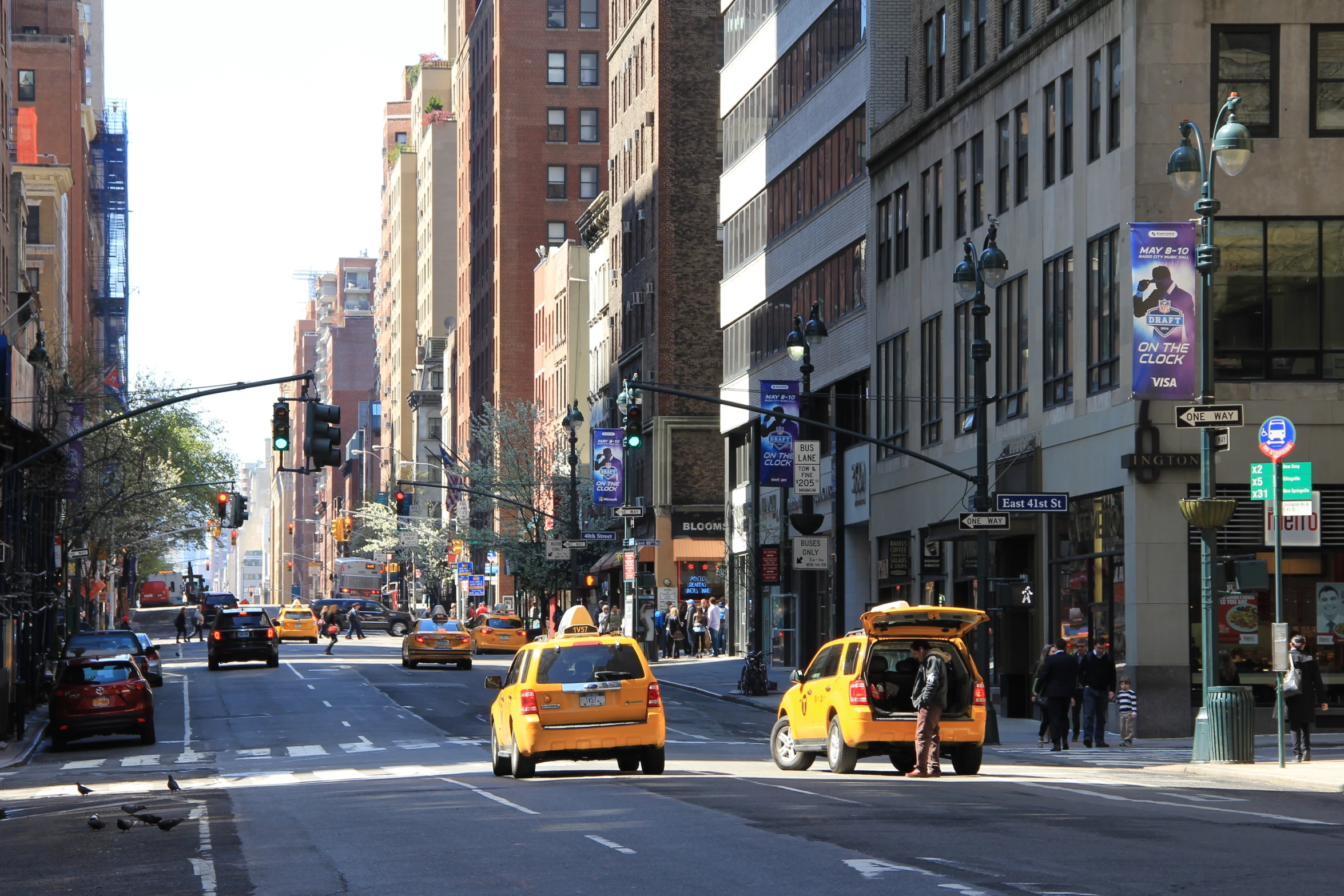 taxi cabs and a taxi cab drive on a street