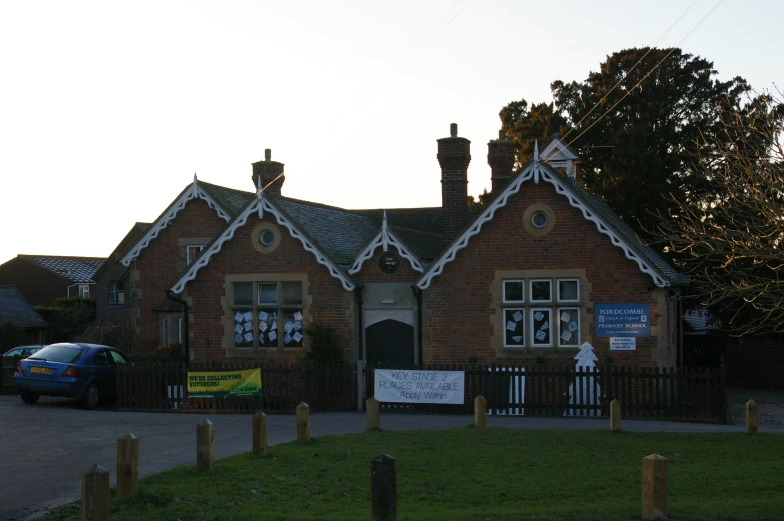 a brown brick building with several windows and some white trim