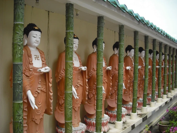 the buddha statues are arranged beside of each other