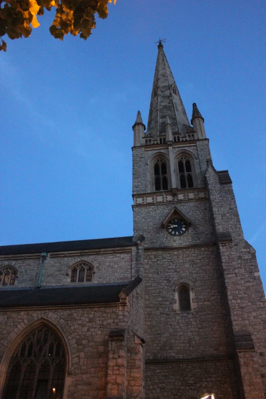 the tall tower of a cathedral against a blue sky