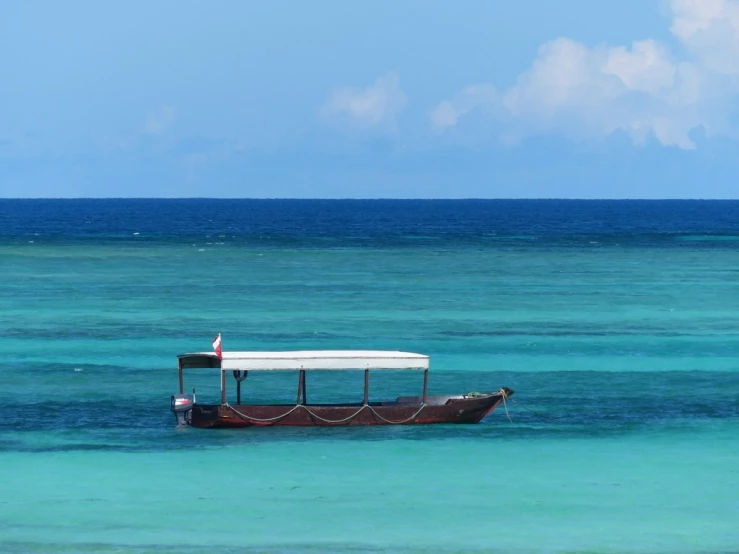 a boat that is in some clear blue water