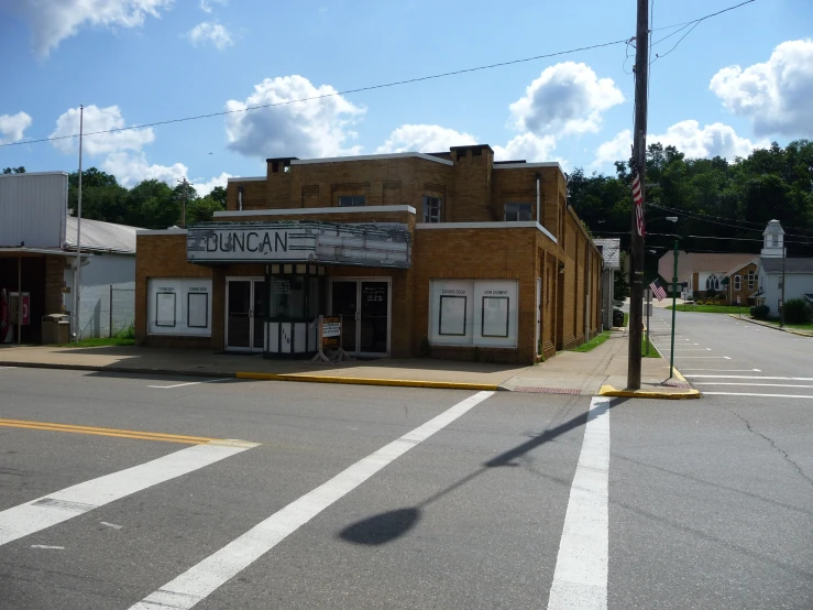 old brick building with broken windows on street corner