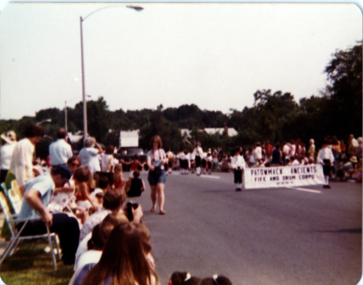 a large group of people are holding a banner in the street