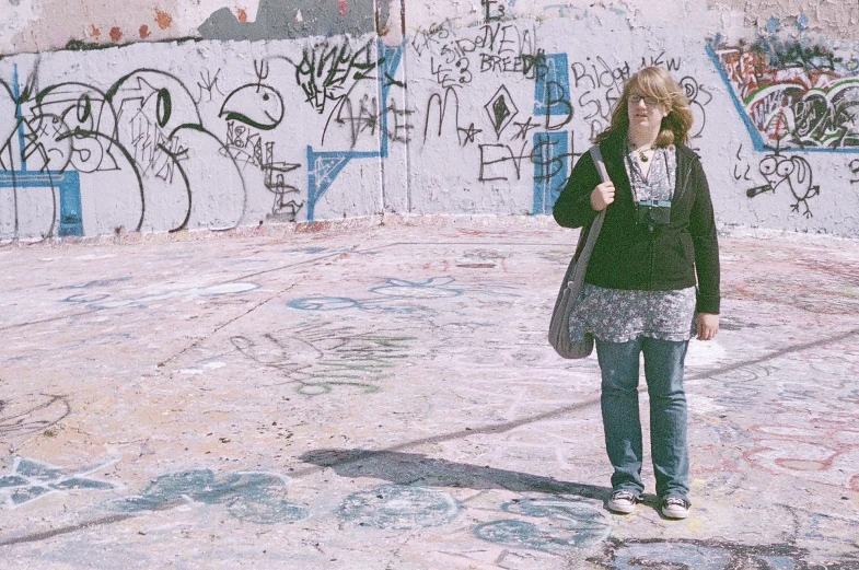 woman talking on a cell phone, surrounded by graffiti