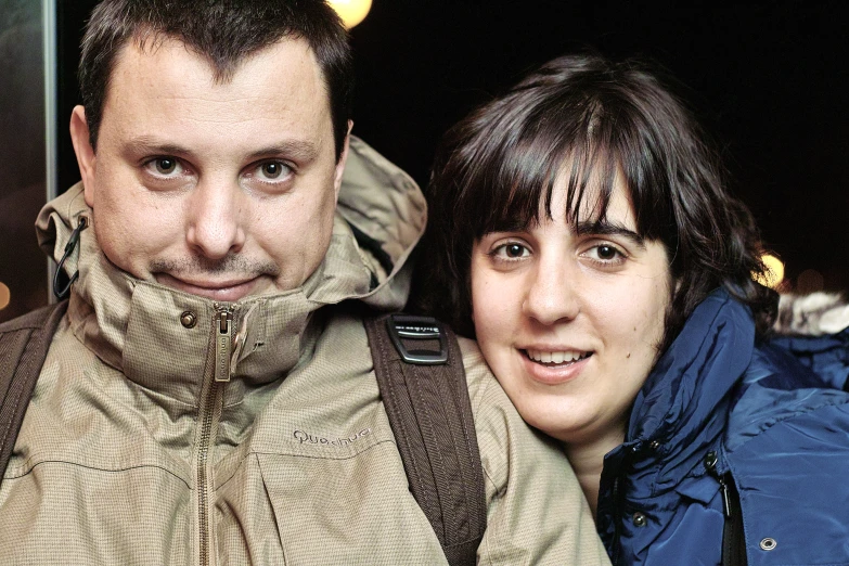 a man and a woman smiling while posing for a picture