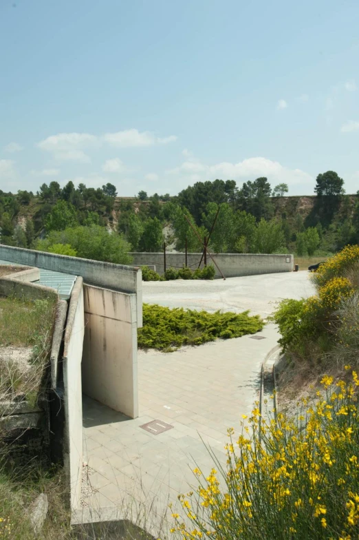 a large wooden structure near flowers and trees