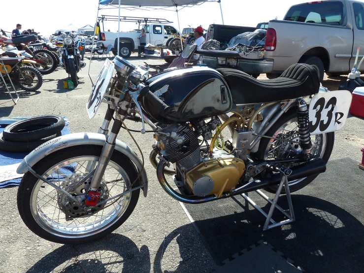 an old motorcycle is parked next to other motorcycles