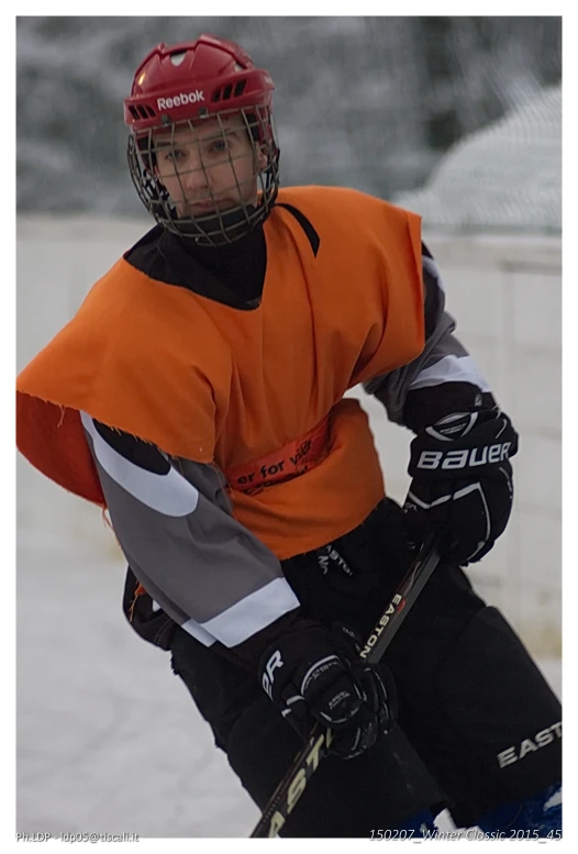 the young man is wearing gloves and wearing a helmet