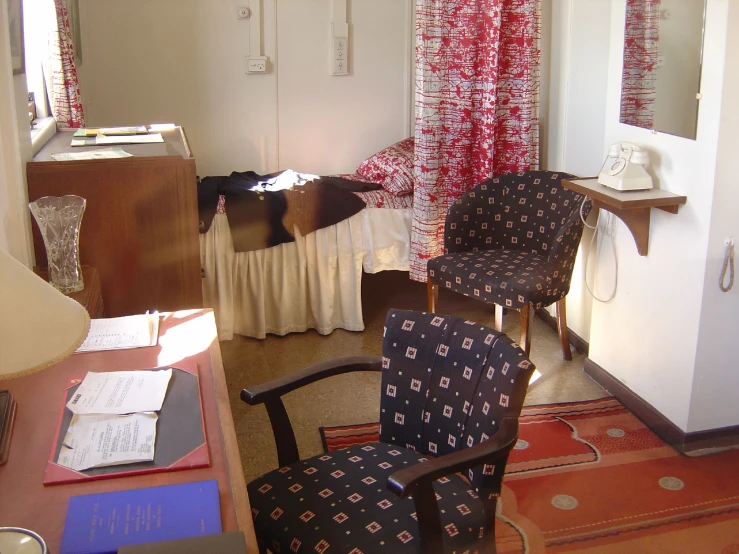 a black chair and table and some curtains