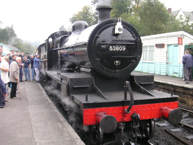 people waiting to get on the train at the station