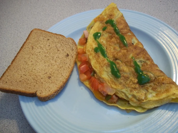 a piece of bread with an omelet and tomatoes