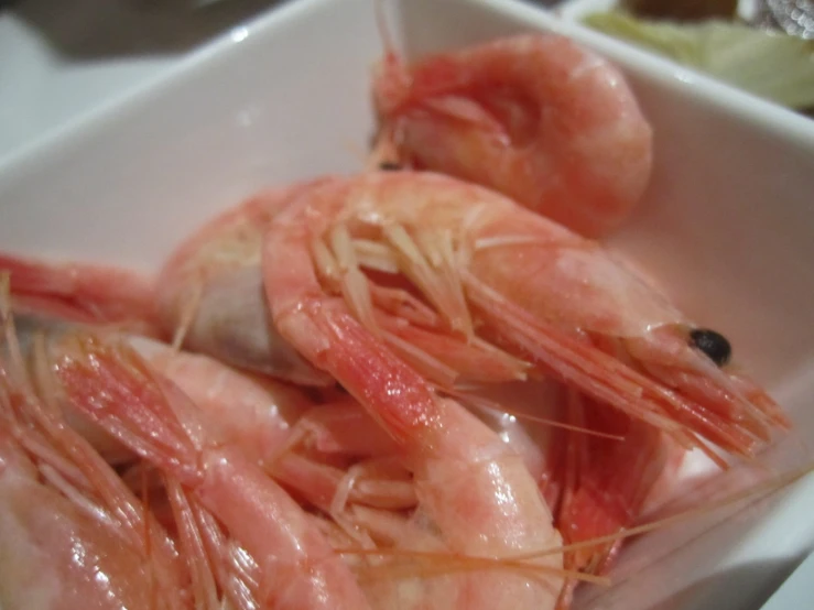 there are some shrimp that are in a small bowl