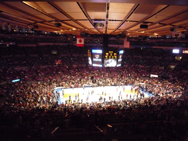 a basketball game inside a stadium with fans