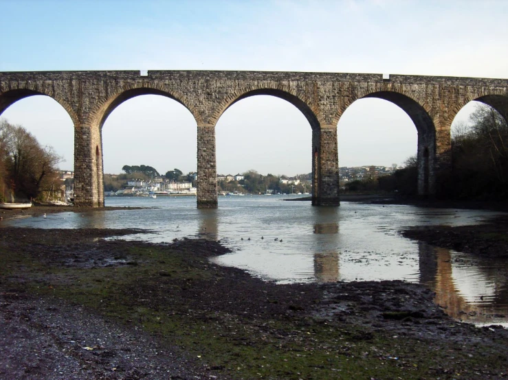 an old bridge surrounded by water under it