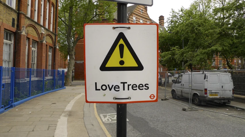 a street sign on a road next to an urban street