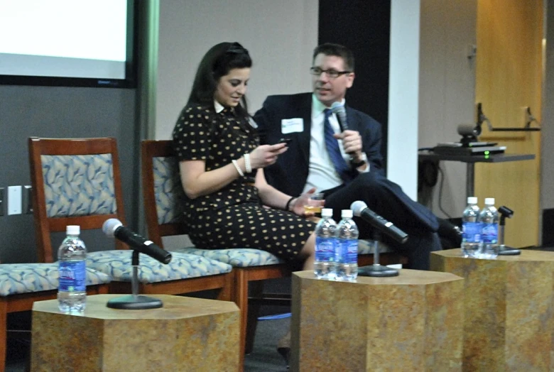 two people in a conference room speaking