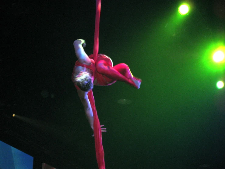 a man performing aerial tricks on a pole