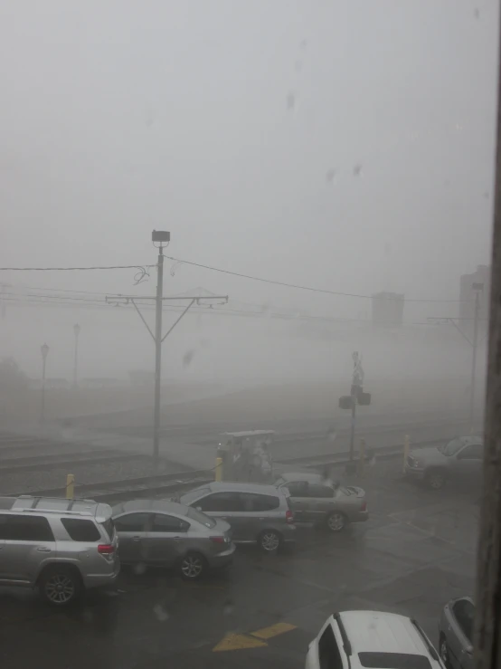 cars stopped at a stop light in the rain