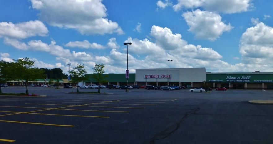 a large parking lot has cars parked next to it